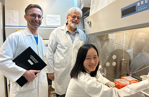 Jean-François Théberge (Research Assistant), Professor Michel L. Tremblay (Principal Investigator), Chu-Han Feng (Ph.D. student) working with cell cultures in a Biological Safety Cabinet.